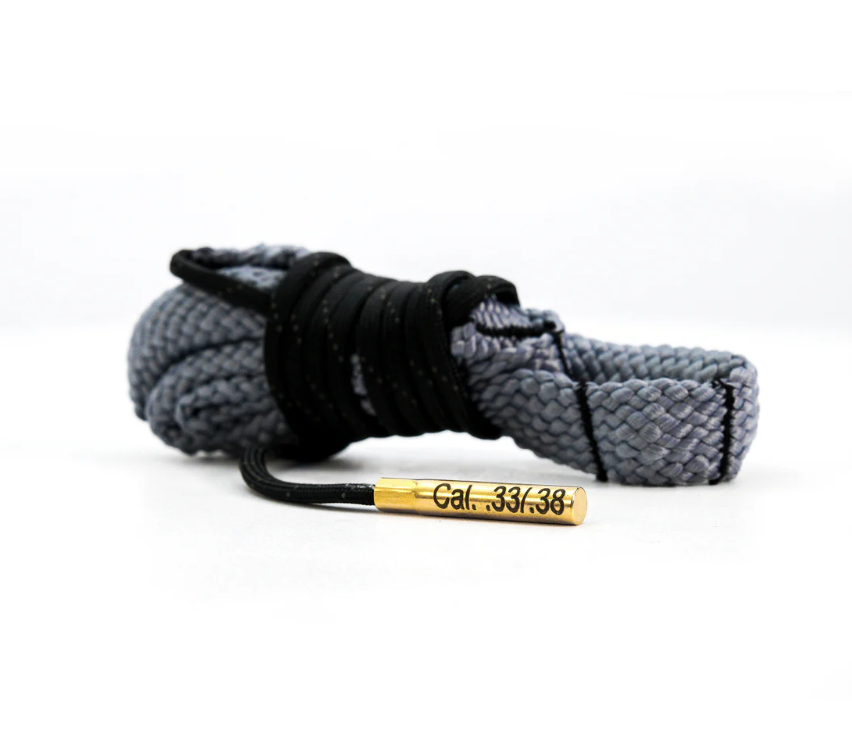 Coiled gray and black rope with a brass end on a white background.